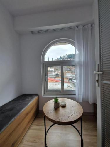 a small room with a table and a window at Petreski Apartments 1 in Ohrid
