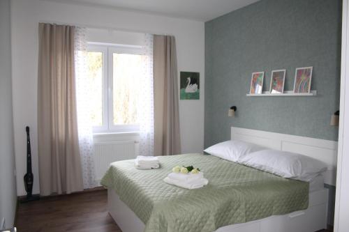 a bedroom with a bed with towels on it at WITH LOVE Marienbad Ap Garden 2 in Mariánské Lázně