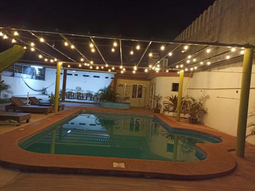 a swimming pool under a string of lights at Casa Quetzal in Peñita de Jaltemba