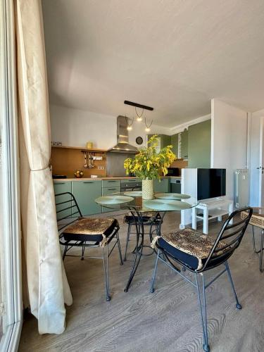 une salle à manger avec une table et des chaises et une cuisine dans l'établissement Stunning sea views, full sun exposure, à Nice