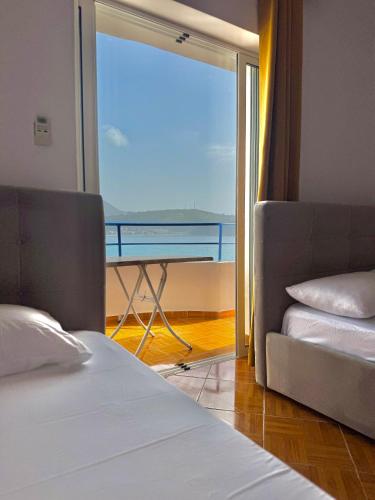 a bedroom with a bed and a view of the ocean at Room with amazing sea view in Himare