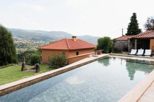 ein Swimmingpool vor einem Haus in der Unterkunft Casa da Chitas in Ponte de Lima
