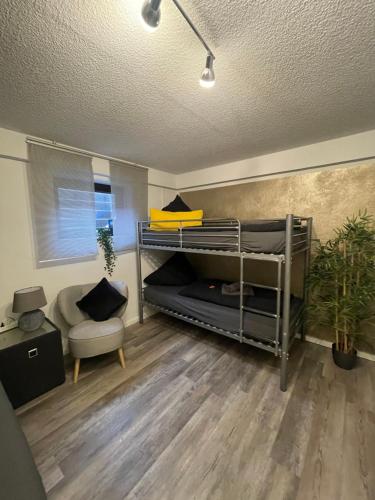 a room with two bunk beds and a chair at Gästehaus Sylvie in Rust