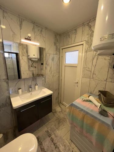 a bathroom with a sink and a toilet at Villa PALA in Kemer