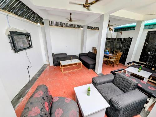 a living room with couches and a tv at White Castle Apartments in Uyo