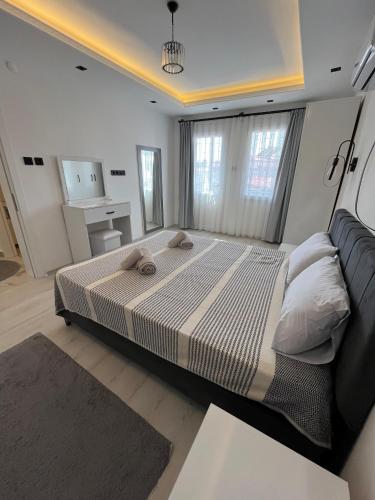 a bedroom with a large bed in a room at Villa PALA in Kemer
