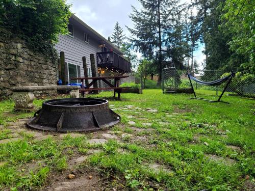 a fire pit in a yard next to a house at PNW Creekside Escape Relax, Unwind, Explore in Marysville