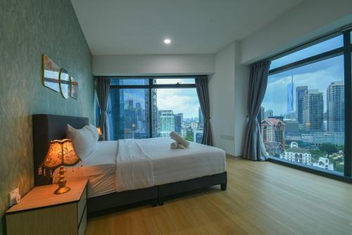 a bedroom with a bed and a large window at Eaton Residence KLCC in Kuala Lumpur