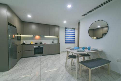 a kitchen with a table and chairs and a mirror at Eaton Residence KLCC in Kuala Lumpur