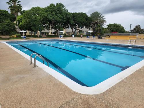 a large swimming pool with blue water at Lecheria con vista al mar in Morro de Barcelona
