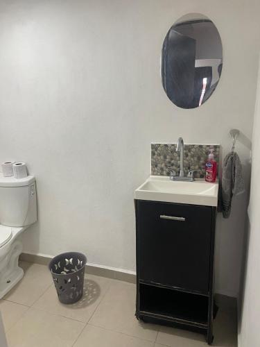 a bathroom with a sink and a toilet and a mirror at Casa SOL in Cobos