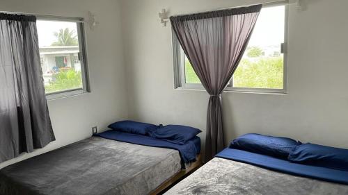 a bedroom with two beds and a window at Casa SOL in Cobos