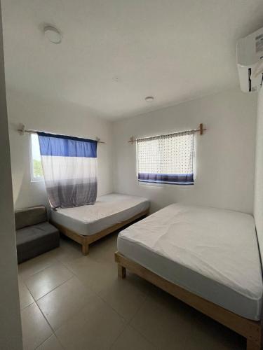 a bedroom with two beds and a window at Casa SOL in Cobos