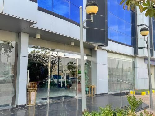 a building with a street light in front of it at Quiet Rooms 12 in Riyadh