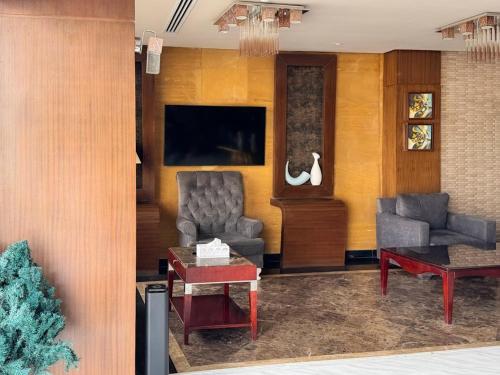 a living room with a couch and a table at Quiet Rooms 12 in Riyadh
