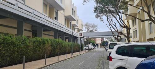 a white car parked on a street next to a building at Casa do Sal in Troia