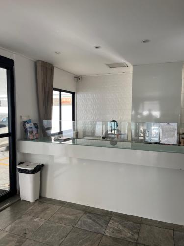 a kitchen with a white counter top in a room at Residencial Neo 1 in Maceió