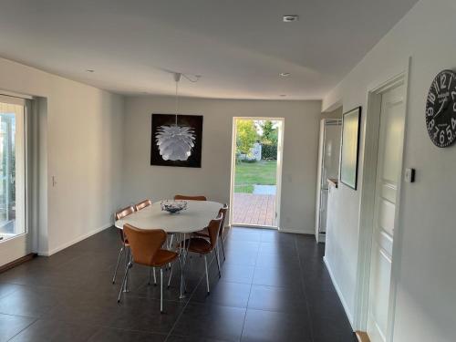 a dining room with a table and chairs at Cozy house in Hjoerring close to city & nature in Hjørring
