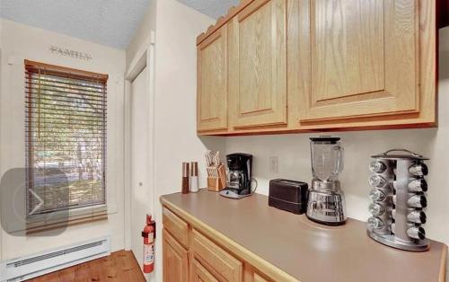 a kitchen with wooden cabinets and a blender on a counter at Mountain Fun-Jack Frost Walk On Whole House in Blakeslee