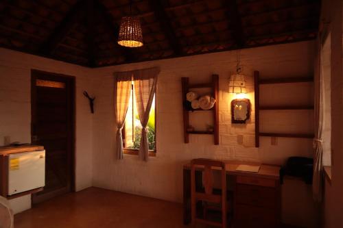 a room with a kitchen with a table and a window at LA LOMA LINDA, Bungalows, Yoga and Feldenkrais, STARLINK INTERNET in Zipolite