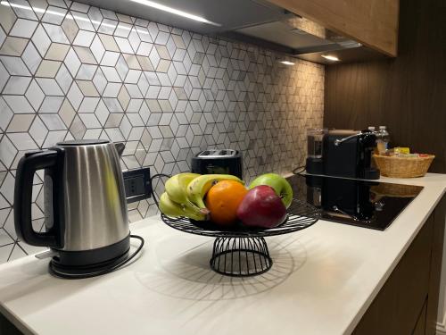 a bowl of fruit on a counter in a kitchen at GRG Charme Apartment in Milan