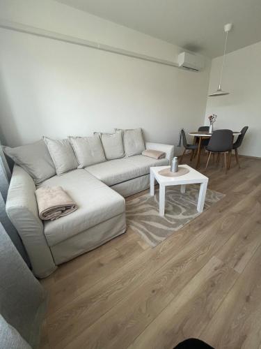 a living room with a white couch and a table at Z&Z Apartman in Szeged