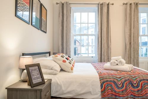 a bedroom with a bed and a window at StayByNumbers - City Centre Victorian Townhouse in Belfast