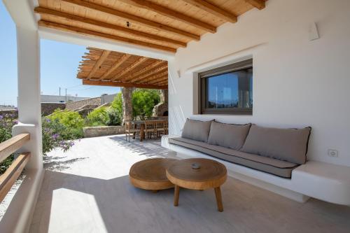 a living room with a couch and a table at Acres Luxe, First Floor Haven & Ground Floor Retreat in Ano Mera