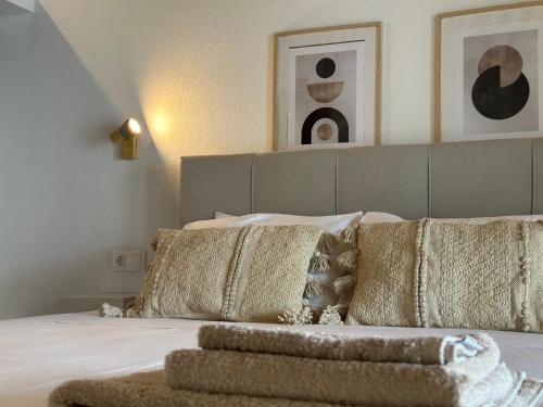a bedroom with a bed with gold pillows at Villa Lazareta in Punta