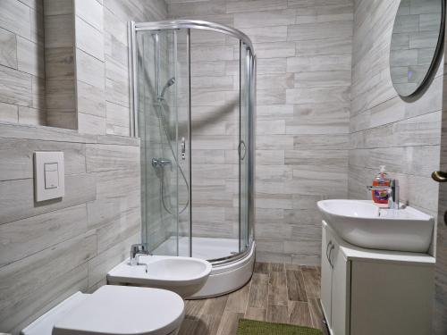 a bathroom with a shower and a toilet and a sink at Blue Horizon Rezevici in Katun