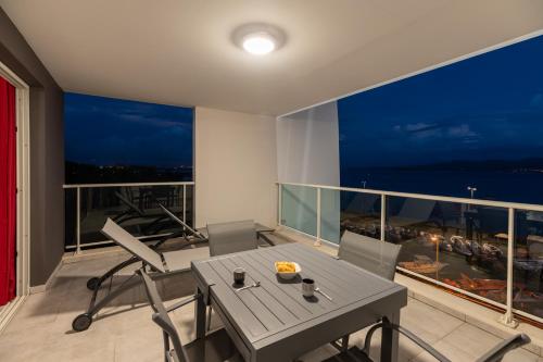 a dining room with a table and chairs on a balcony at B&B HOME Fort-de-France Marina in Fort-de-France