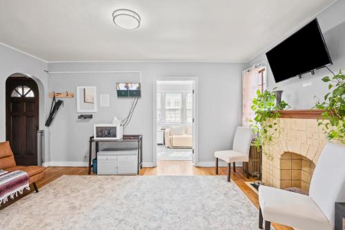 a living room with a fireplace and a tv at Large apartment with multiple sleeping options in Munhall