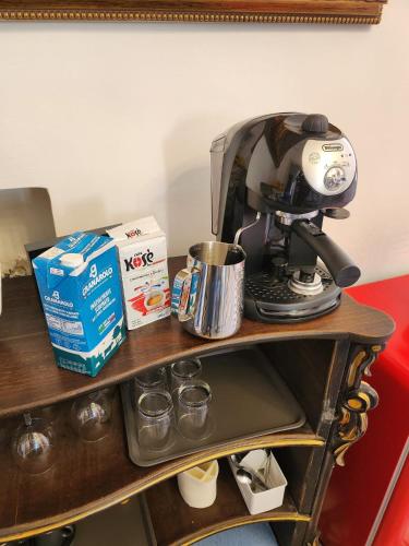 a coffee maker on top of a table at La Maison Royale in Toritto