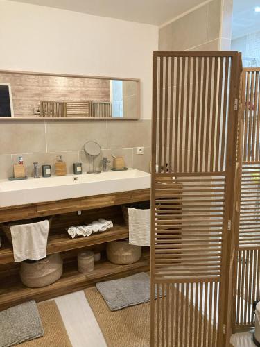 une salle de bain avec un lavabo et un miroir dans l'établissement Charmant Horse and Cottage Hideaway, à Doulezon