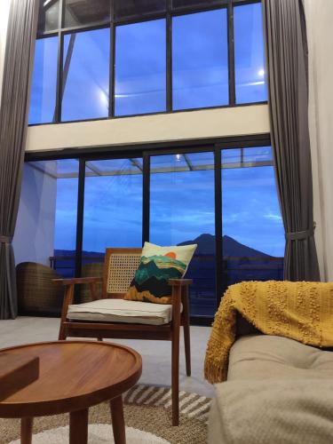 a living room with a large window at Batur view Homestay - Loft in Kintamani