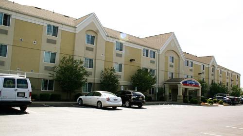 a large building with cars parked in a parking lot at Candlewood Suites Harrisonburg by IHG in Harrisonburg