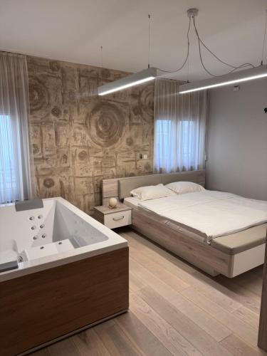 เตียงในห้องที่ Apartman Ari