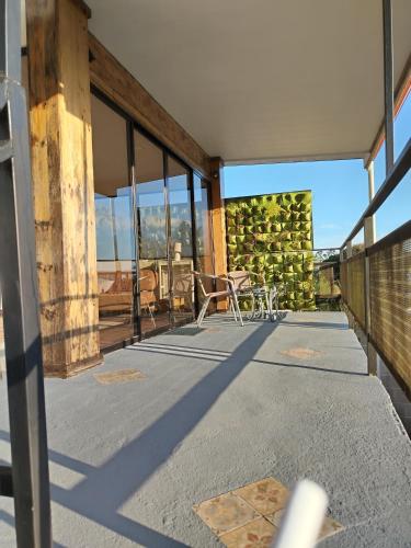 a balcony with tables and chairs on a building at Preciosa cabaña en Fraijanes in Fraijanes