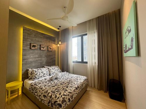 a small bedroom with a bed and a window at Designer Touch Luxurious Stay with Infinity Pool in Petaling Jaya