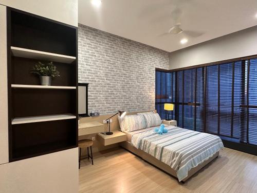 a bedroom with a bed and a desk in it at Designer Touch Luxurious Stay with Infinity Pool in Petaling Jaya
