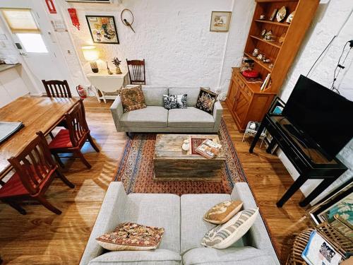 a living room with a couch and a table at Cottage Bliss on Moonta Main St in Moonta