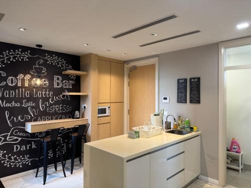 a kitchen with a chalkboard wall with a coffee bar at Designer Touch Luxurious Stay with Infinity Pool in Petaling Jaya