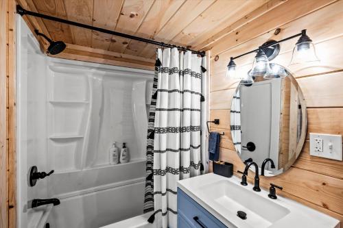 a bathroom with a sink and a shower at Holidays in Cozy Mountain Cabin - Near Dollywood, Parkway, Biggest Zipline - Hot Tub, Games, Hammock in Sevierville