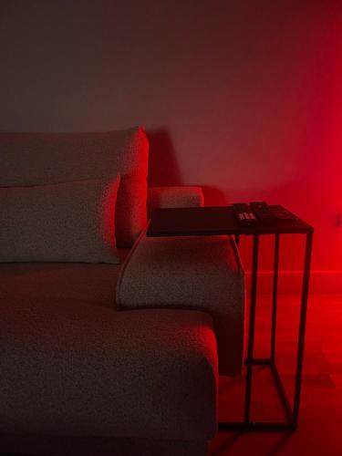 a bedroom with a bed with a table with a red light at 180° View Apartment in Diamond Building Skopje in Skopje