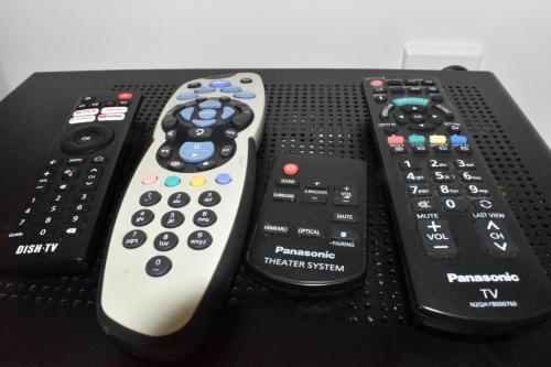 three remote controls sitting on top of a table at Te Hoiere Guesthouse in Havelock