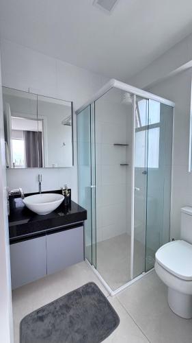 a bathroom with a sink and a toilet and a shower at Quarto São João - familiar in Campina Grande