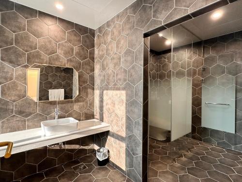 a bathroom with a sink and a mirror at Restia Incheon Bay Hotel in Incheon