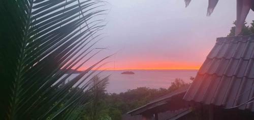 a view of the ocean at sunset from a house at Kohrong Sea Views Bungalows in Koh Rong Island