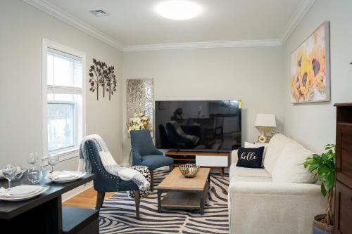 a living room with a couch and a table at 40-Newly renovated, stylish and beautiful apartment with 4br in Boston