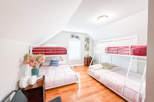 two bunk beds in a room with a table at 40-Newly renovated, stylish and beautiful apartment with 4br in Boston